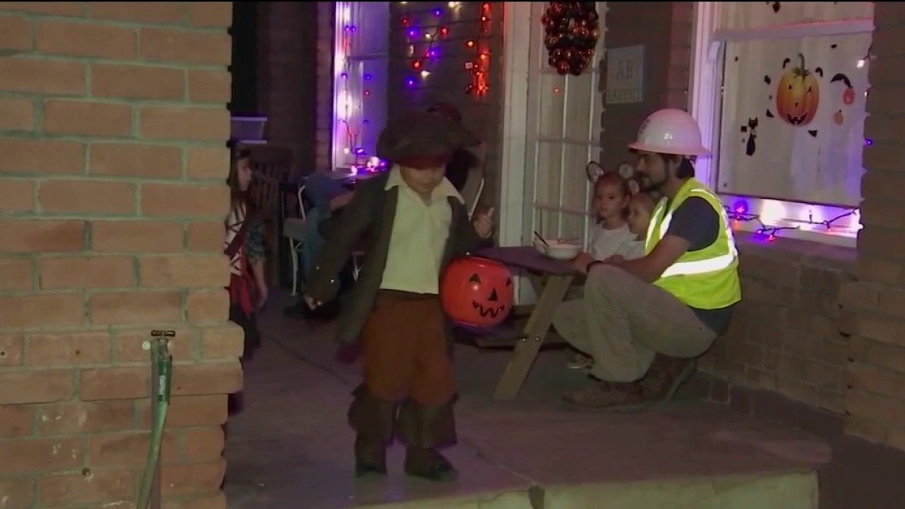 Children trick-or-treating safely with parents in Atherton